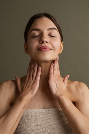 Mujer realizando masaje facial con aceites y oligoelementos profesionales Vagheggi.